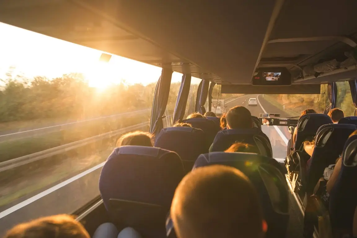 Bussresor senom skåne med passagerare och solen skinandes inifrån bussen.